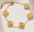 Gold chain bracelet with textured clover charms