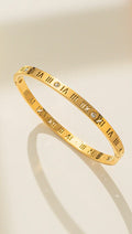 Gold open cuff bracelet with engraved Roman numerals