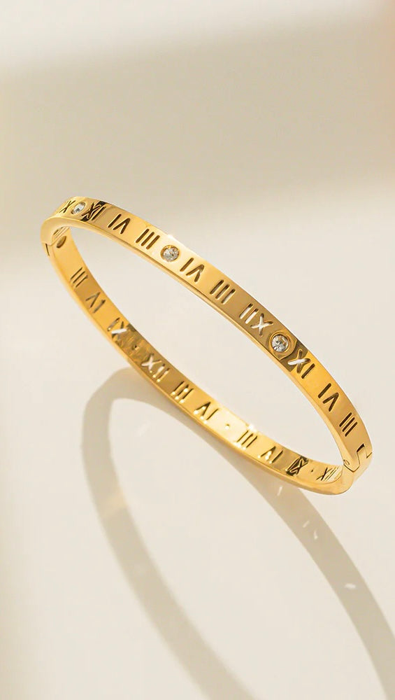 Gold open cuff bracelet with engraved Roman numerals