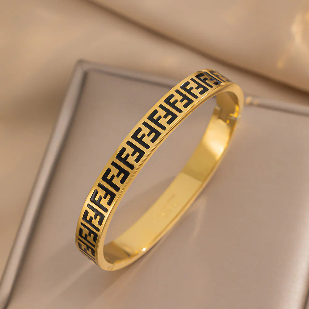 Gold enamel pattern bangle bracelet with star accent